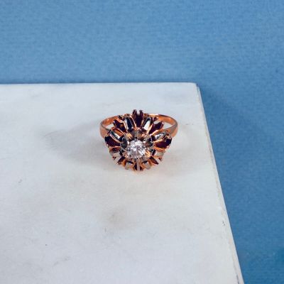 a close up of a diamond ring on a white surface