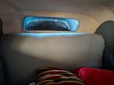 an image of a car with a bed in the back of it