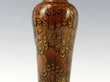 a vase that is sitting on a stand on a white surface