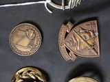 four different types of badges on a black surface