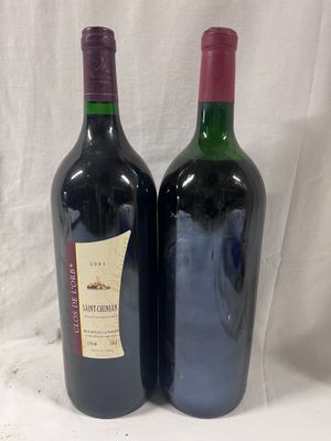 two bottles of wine sitting next to each other on a table