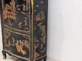 a black cabinet with a black and gold design on it