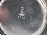 a silver plate with a picture of a dog on it