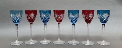 six wine glasses are lined up in a row on a table