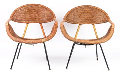 pair of wicker chairs with black metal legs on a white background
