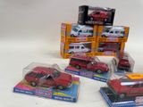 three red toy cars are sitting on top of each other on a table