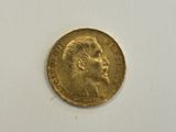 a close up of a gold coin with a man ' s face on it
