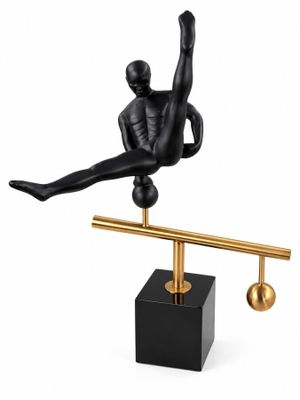 the figurine of a man is balancing on a balance beam