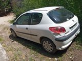 a small white car parked on the side of the road