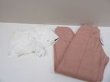 a pair of pink pants and a white shirt on a table