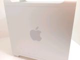 an apple computer sitting on top of a white table