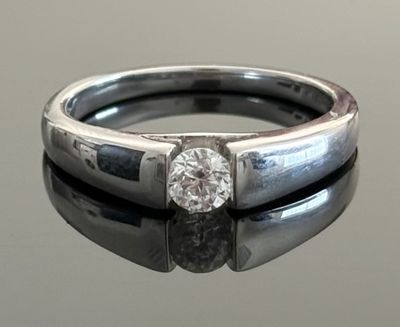 an image of a diamond ring on a reflective surface