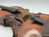 a close up of a violin on a white surface
