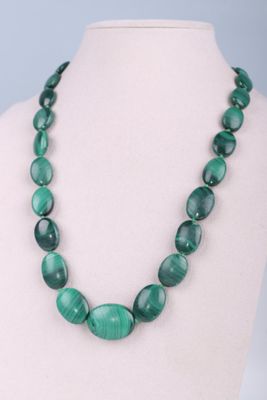 a close up of a necklace on a mannequin mannequin
