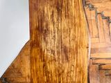 a wooden chair that is sitting on a hard wood floor