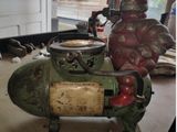 a green and red object on a table in a garage