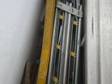 a pile of metal pipes in the corner of a room