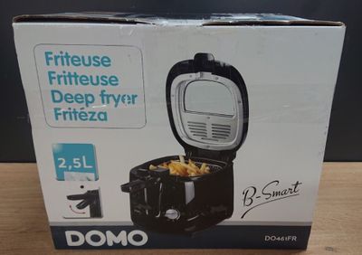 boxed box of domo deep fryer with lid open on wooden table