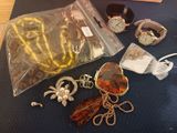 a bag of jewelry sitting on a table next to a bag of jewelry