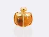 an image of a gold and tiger ' s eye perfume bottle