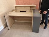 a man that is measuring the height of a desk
