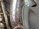 a silver saxophone sitting on top of a table