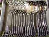 a lot of spoons and forks in a box