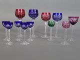 many different colored wine glasses lined up on a table