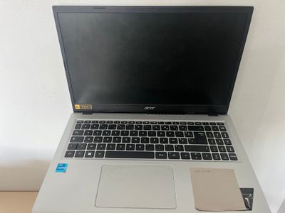 an open laptop computer sitting on top of a wooden desk