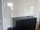 a white board on the wall in a room