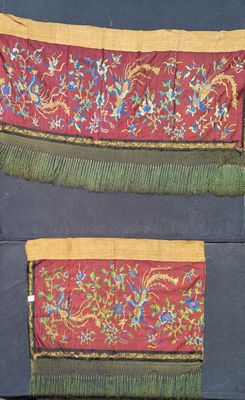two pieces of cloth with fringes on them sitting on a blue surface