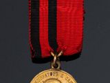 an image of a medal with a red ribbon around it