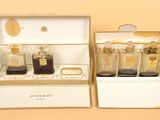 three bottles of perfume sitting in a box on a table