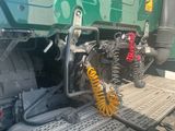 a green truck with yellow springs on the back of it