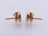 a pair of yellow gold earrings with a round design