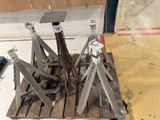 a wooden pallet with a couple of metal legs on top of it