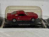a red truck in a glass case on a table