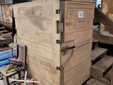 a wooden box that is sitting in the middle of a room