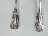 two spoons and a fork on a table