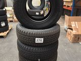 tires stacked on pallets in a warehouse with boxes and pallets