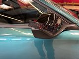 a close up of a car ' s side mirror with a sticker on it