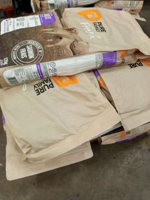 several bags of food are stacked on top of each other in a warehouse