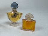 three perfume bottles sitting next to each other on a table
