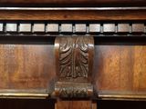 a close up of a wooden shelf with a clock on it