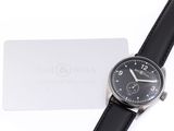 an image of a black watch with a white tag on it
