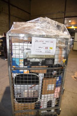 a metal cart with many items in it in a warehouse