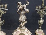 three antique bronze figurines on a black background with a black background