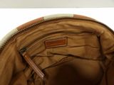 the inside of a brown and white purse with a zipper