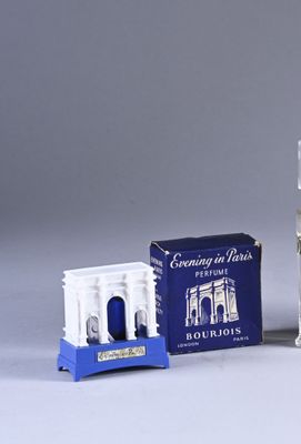 a bottle of cologne next to a small box of cologne