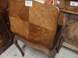 a wooden chair with a basket on top of it
